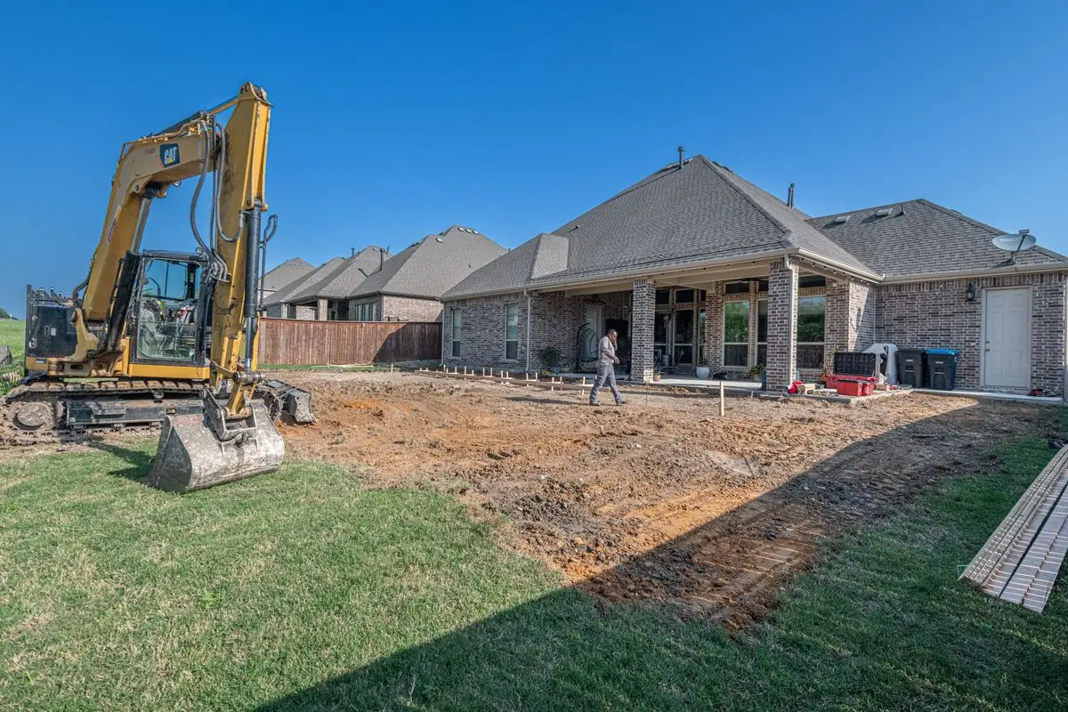 Old surface removed and ground prepared behind a house