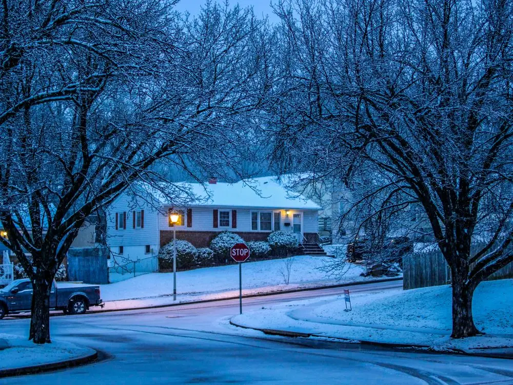 Residential building beside a snow-covered roadway